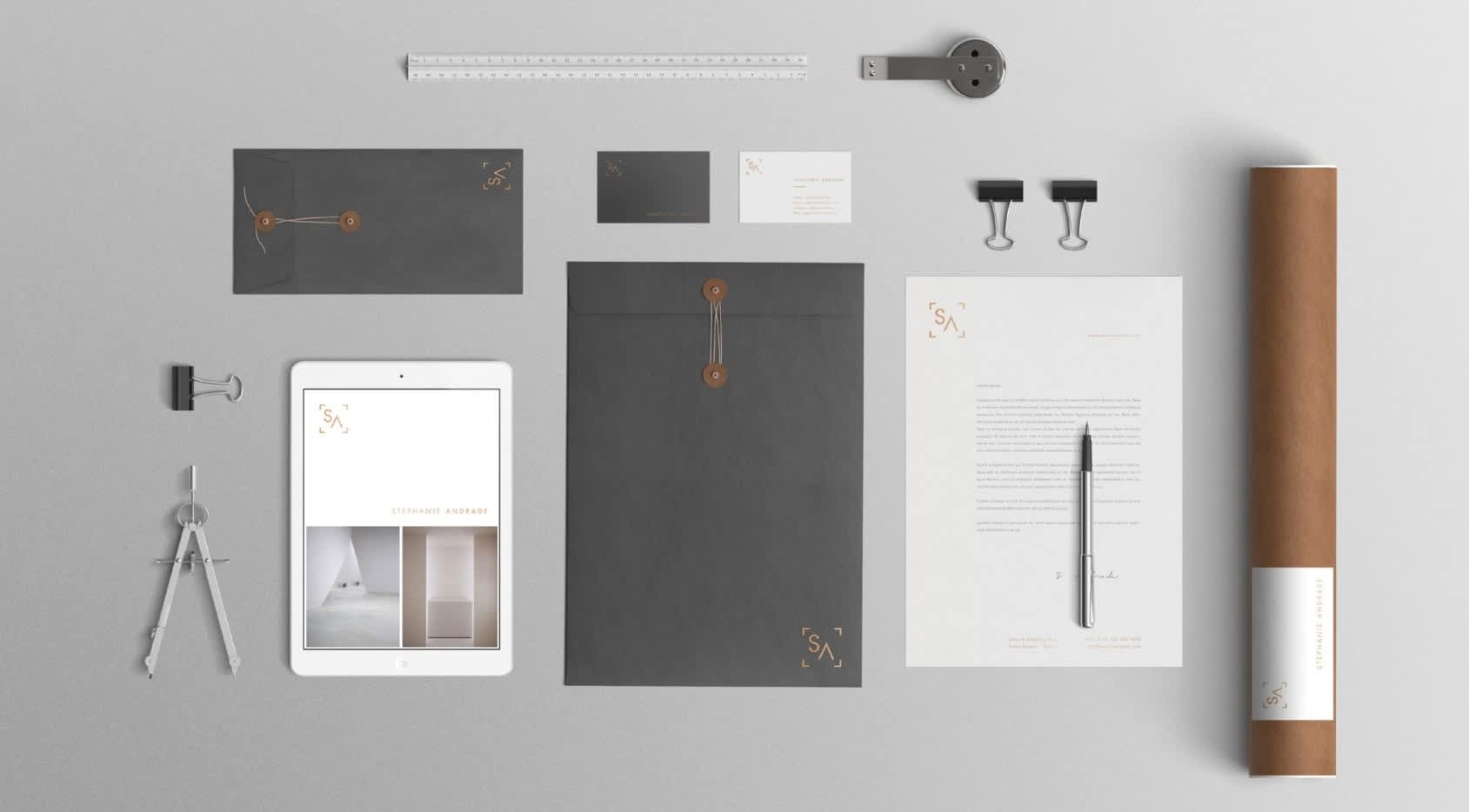 Collection of envelopes, tools, stationary and business cards showing an architecture firm&rsquo;s branding
