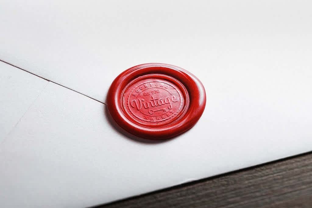 red wax seal on a white envelope