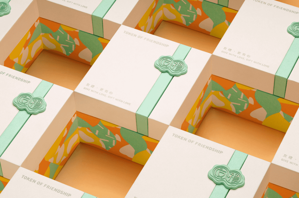 open yellow, white and green box, showing a gold necklace