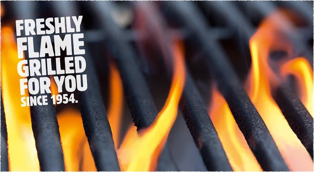 image of black grill grates with flames poking throgh