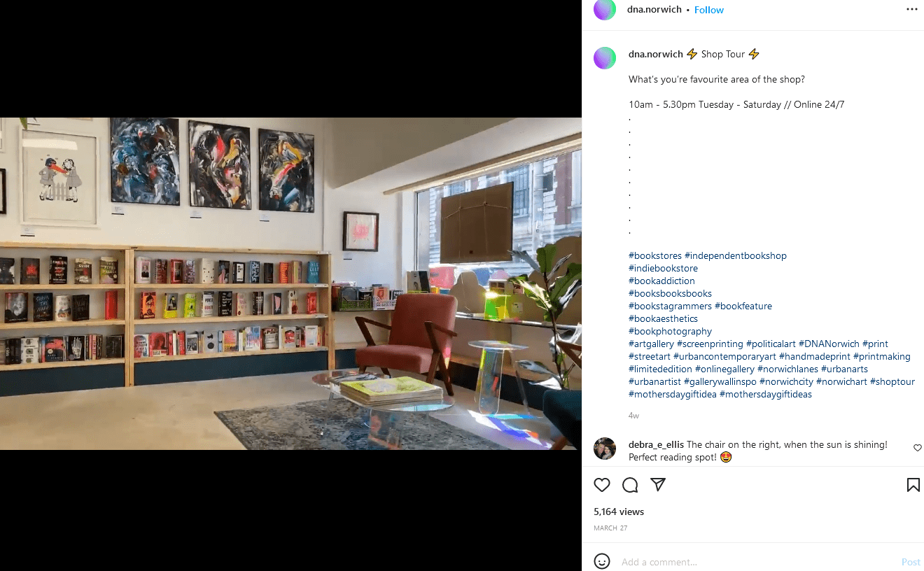 An orange reading chair with shelves of books in the background