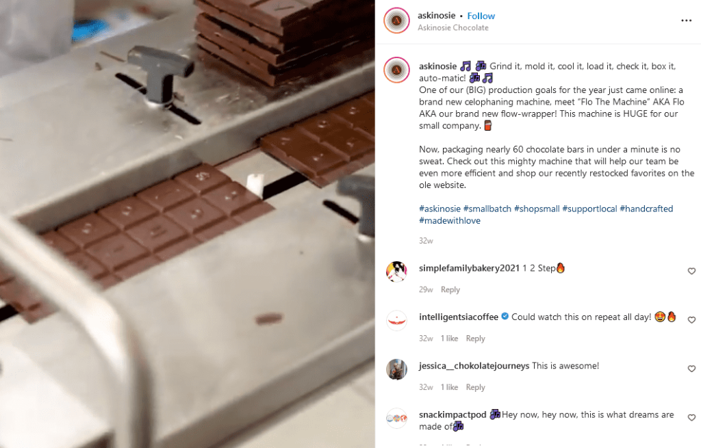 A stack of chocolate bars are processed by a machine