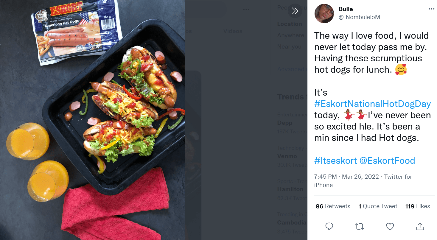 Three hotdog sandwiches in a black tray