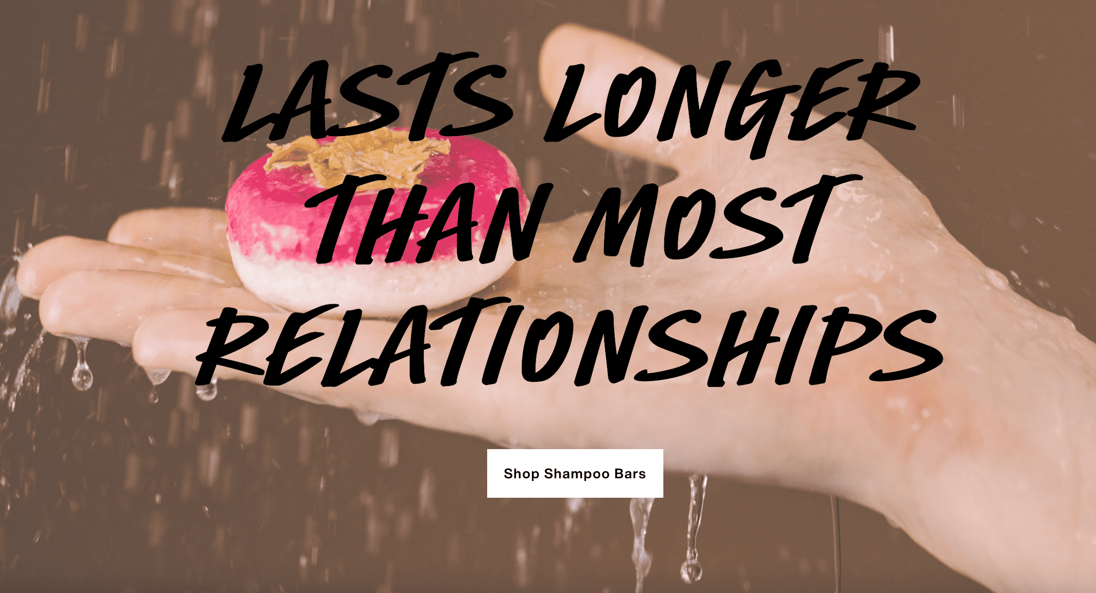 Hand holding bar of shampoo by cosmetics brand Lush, with advertising slogan scrawled across.