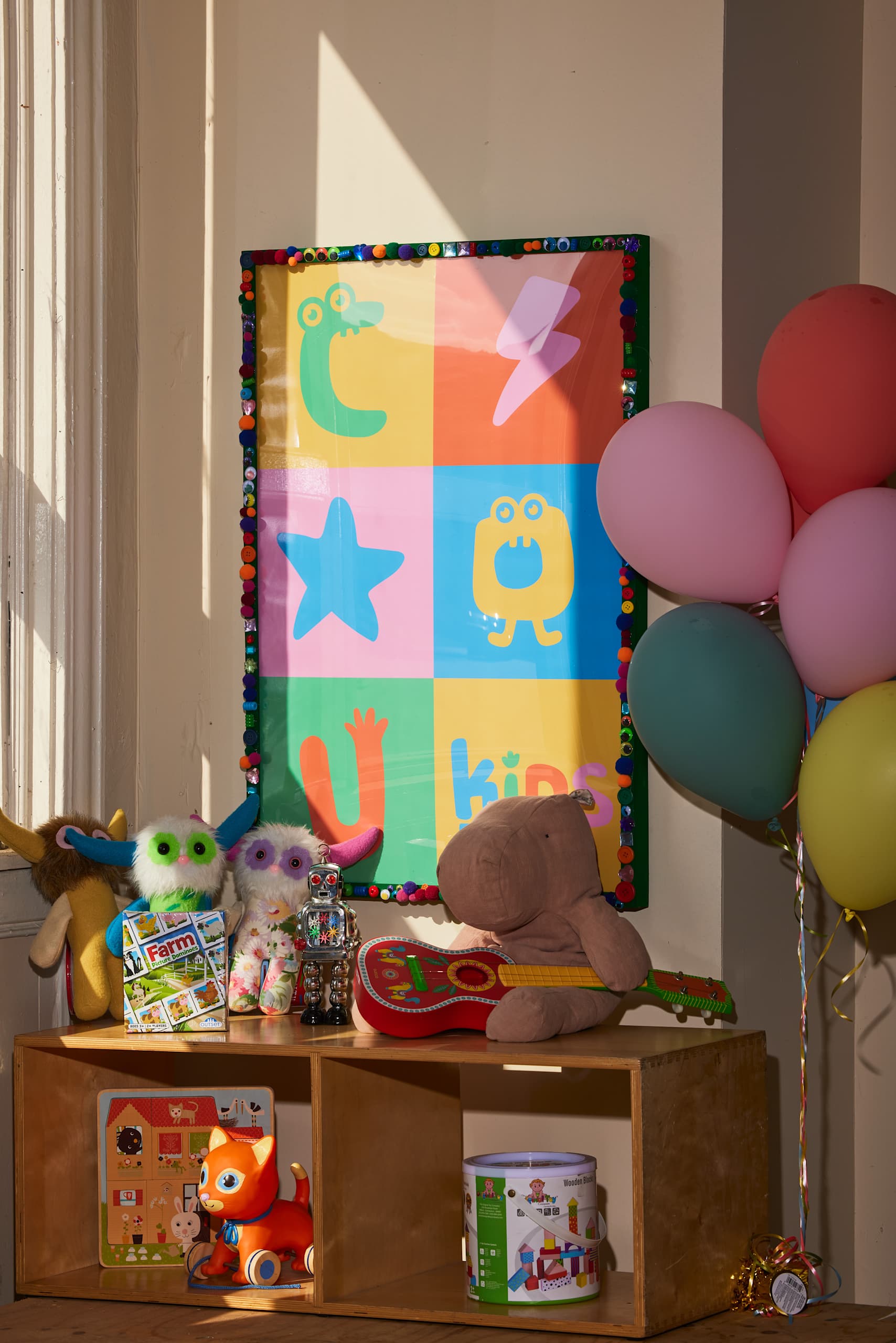 Colorful children&rsquo;s brand poster features a few rows of bold squares in the brand colors and featuring the logo