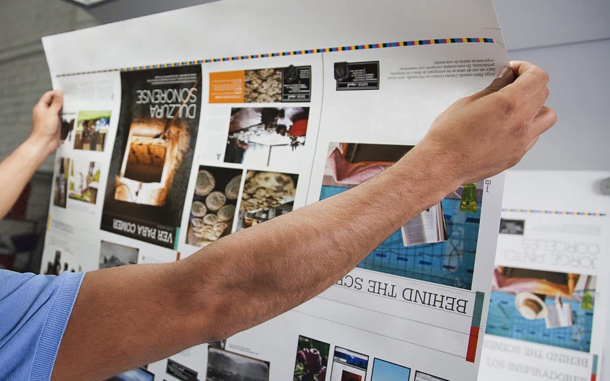 Close-up of a person checking an offset printing proof