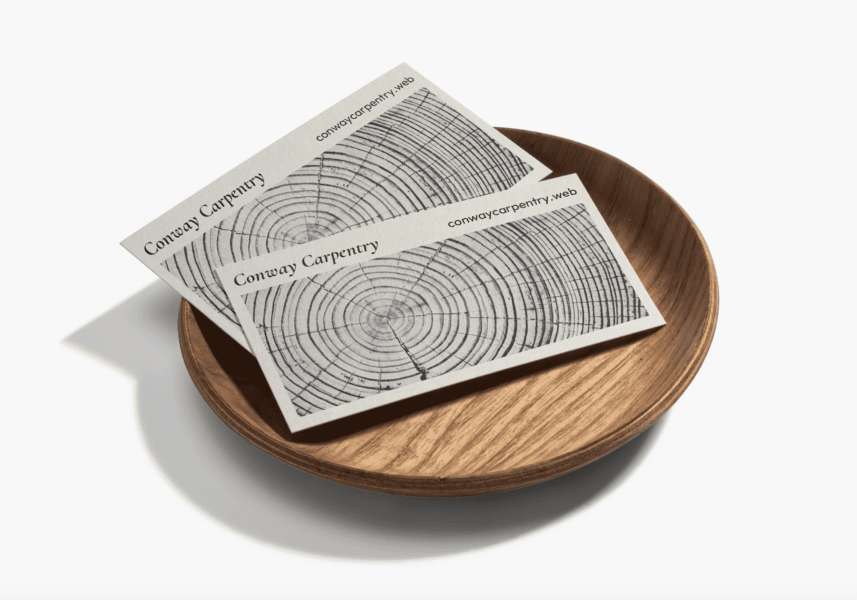 Two bamboo business cards inside a wooden bowl