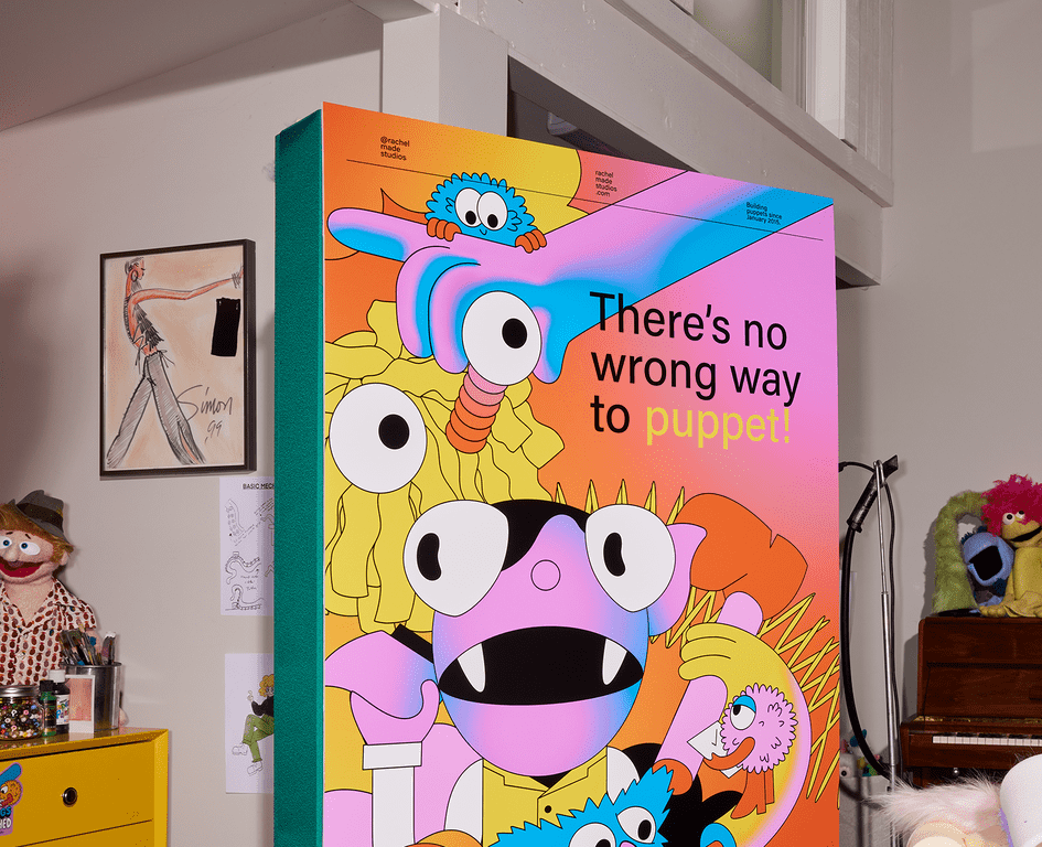A multi-colored, bright standing banner with the words “There’s no wrong way to puppet” and illustrations of abstract creatures