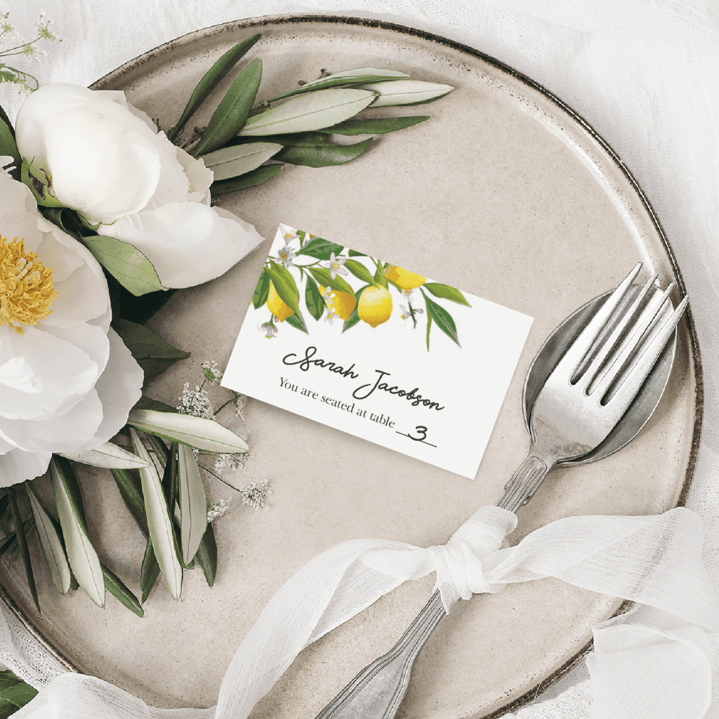 white place card featuring a colorful floral design at the top