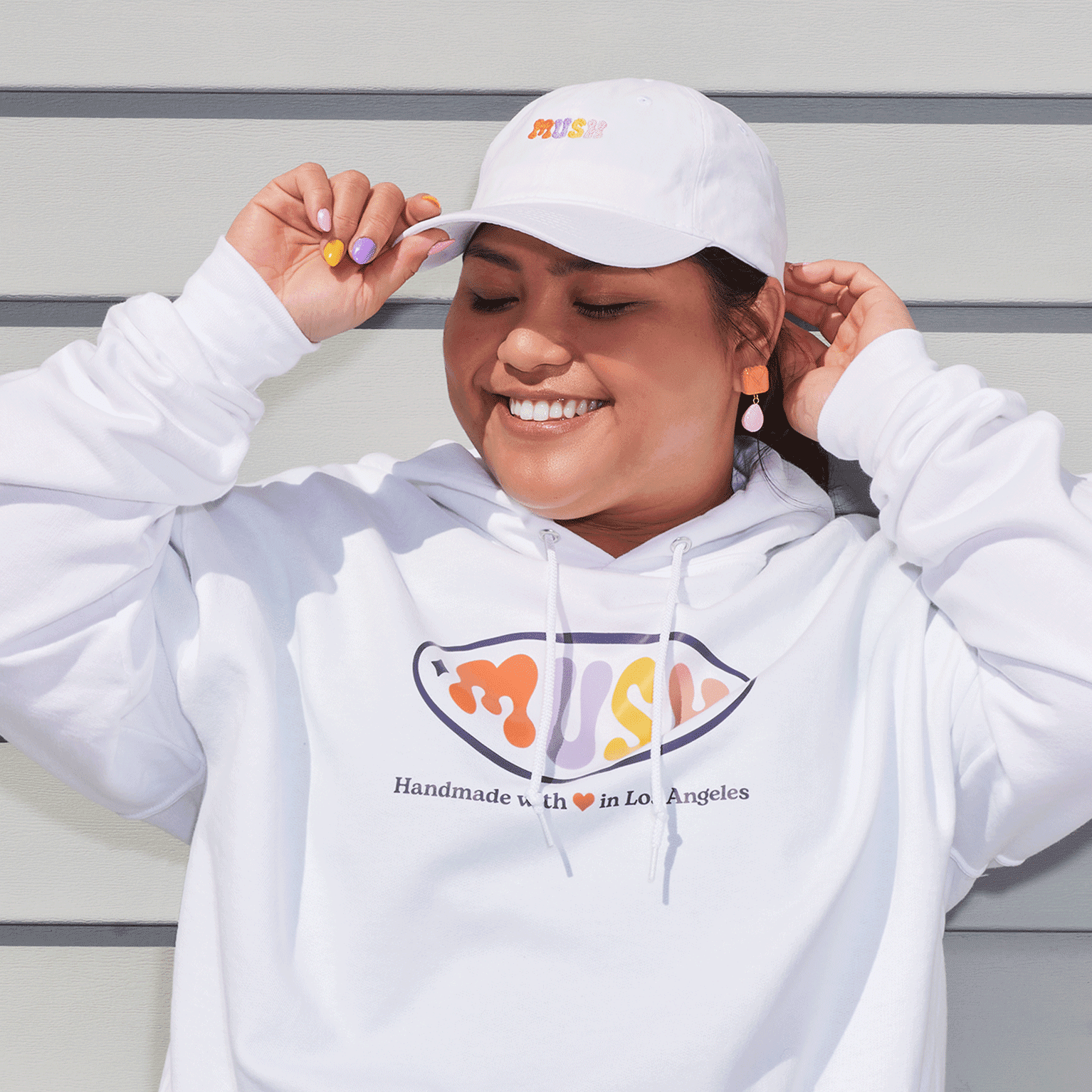 Woman wearing white custom cap and white hoodie