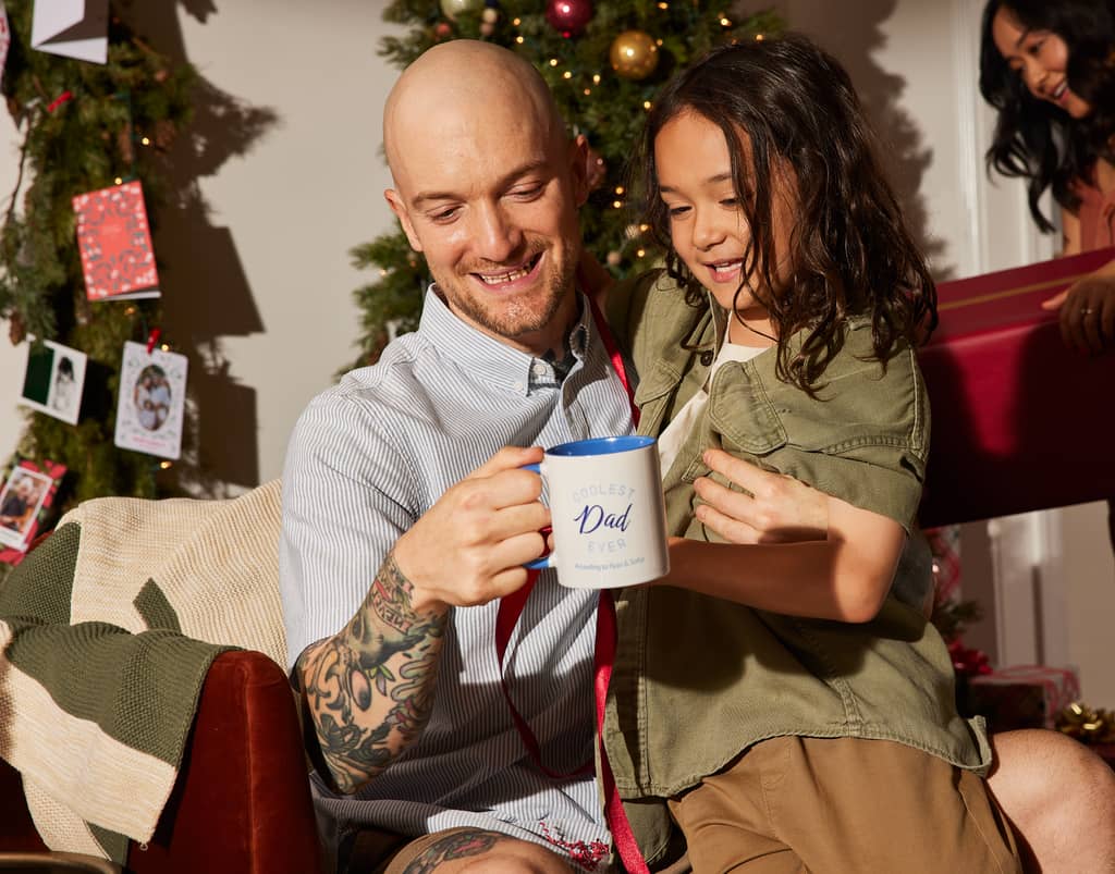 Dad holding a custom mug and daughter celebrating Father&rsquo;s Day