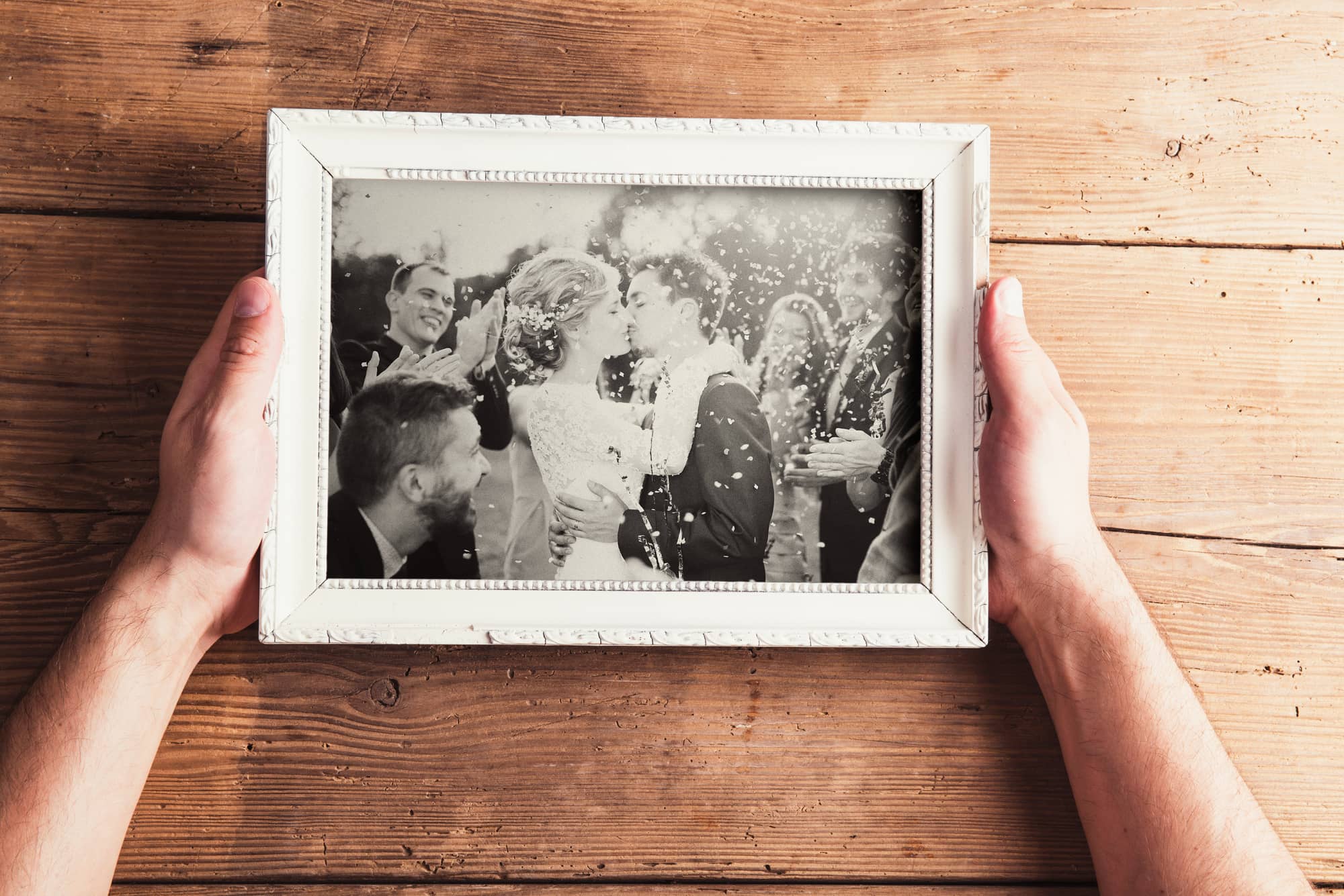 A personalized wedding photo gift in a white frame