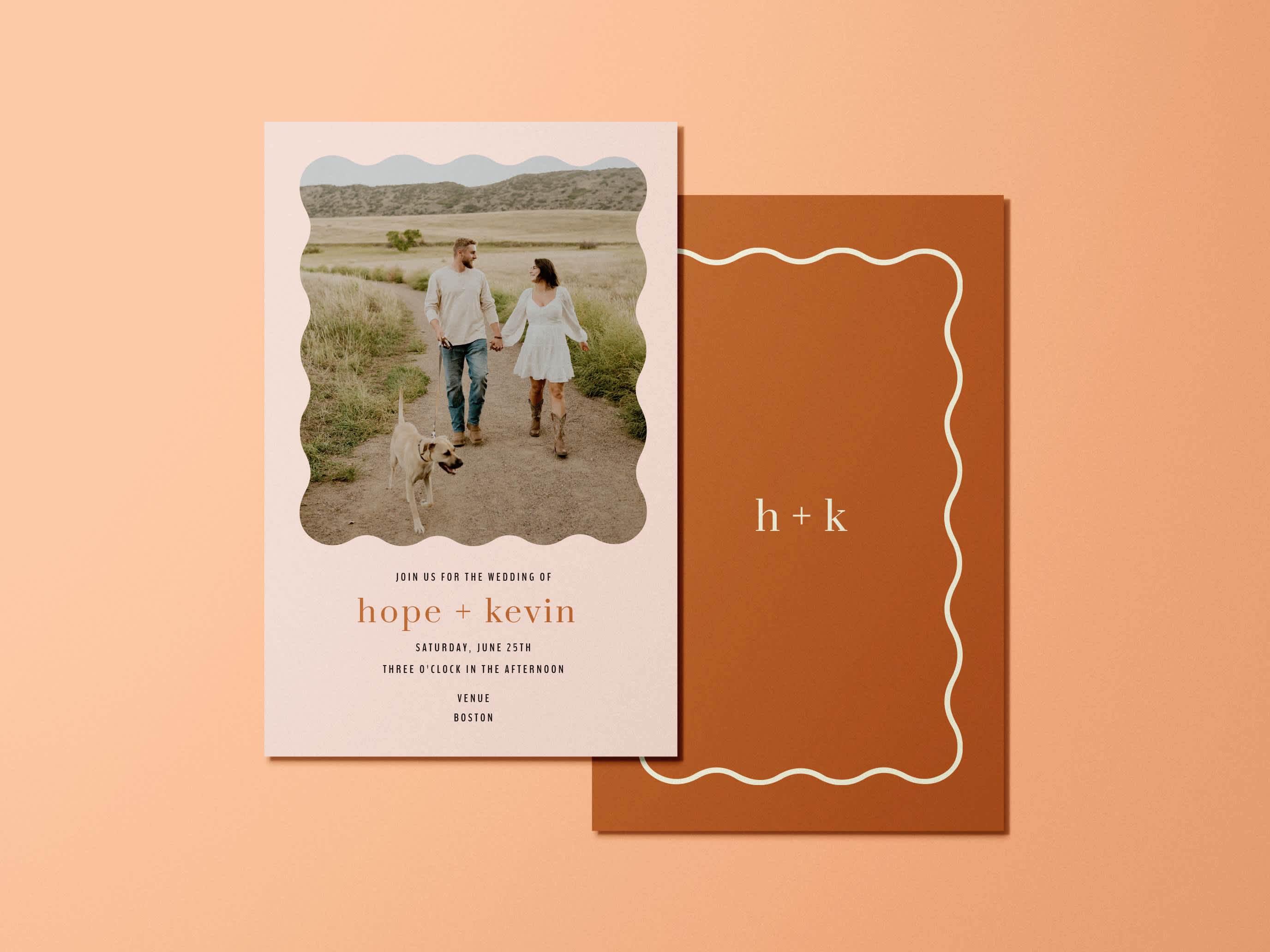 a wedding invitation featuring a photo of a man, woman, and their dog with information about their ceremony on one side, and a simple designs with a border and the letters &ldquo;H+K&rdquo; on the reverse