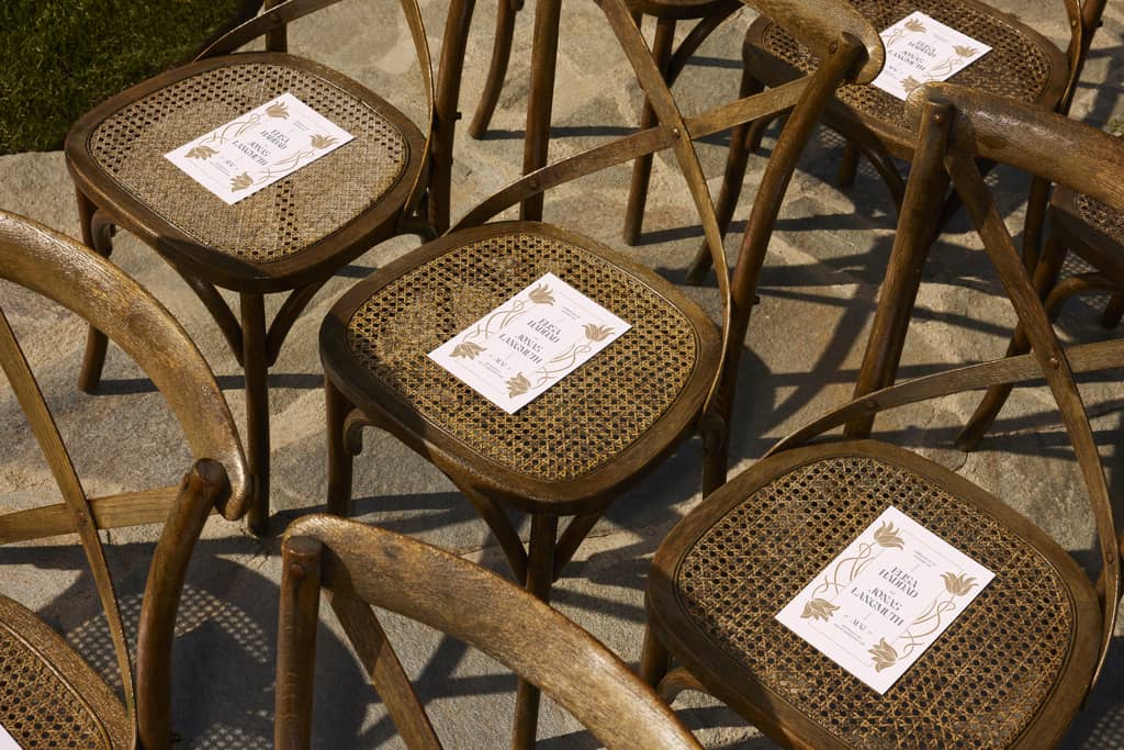 seats with a customized wedding program placed on each