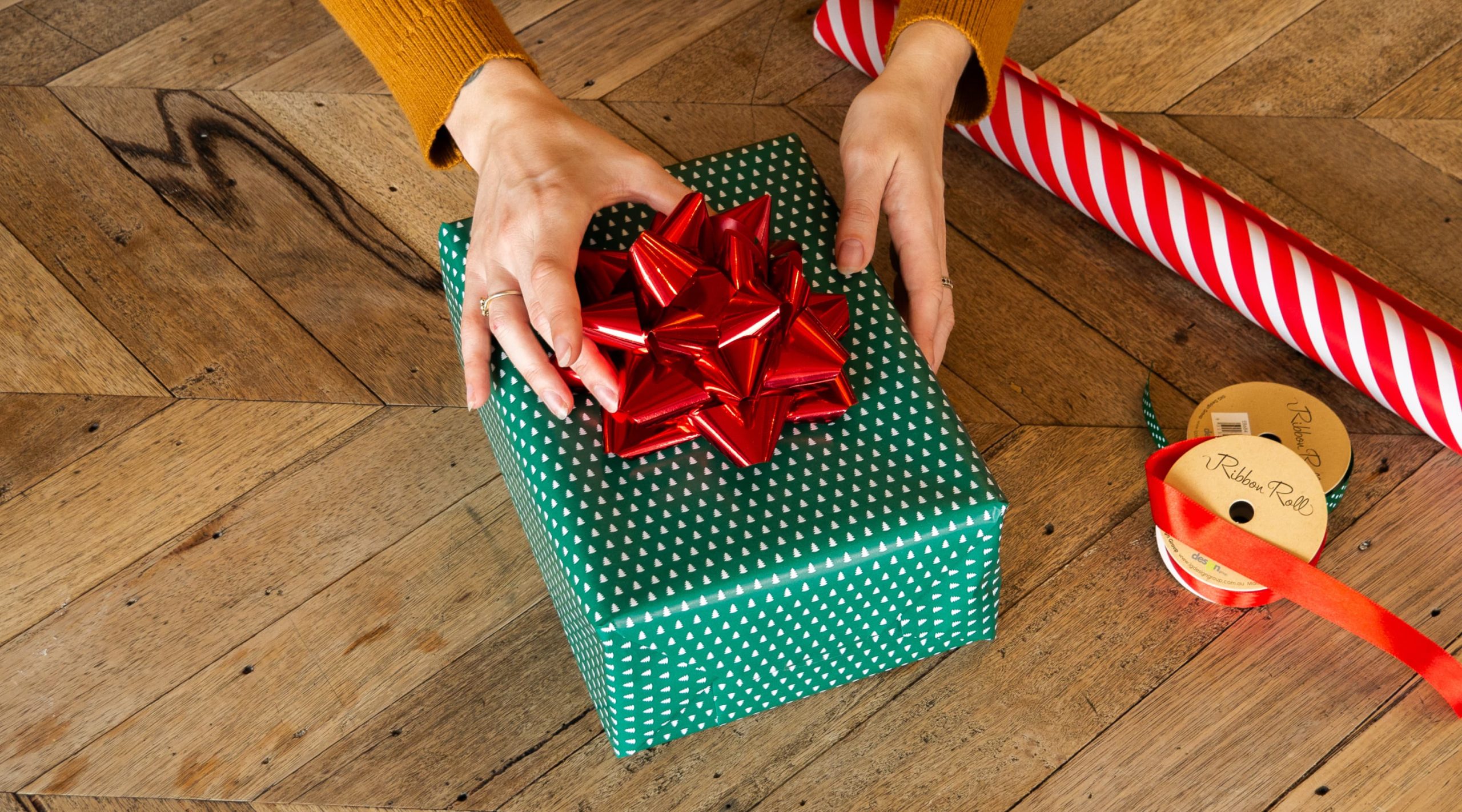 Adding a ribbon, bow or tag to the wrapped present