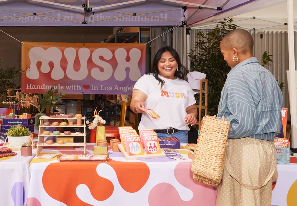 Business representative of Mush wearing a branded t-shirt at a trade show