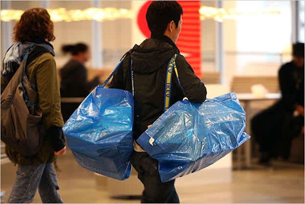 Man carrying iconic Ikea shopping bags