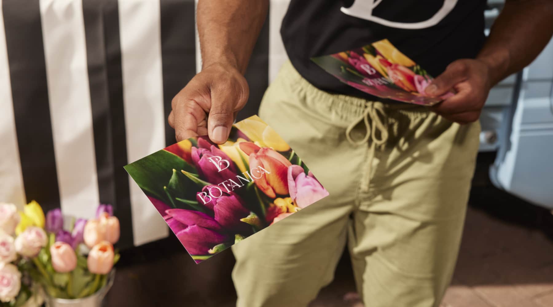 A person handing out branded postcards