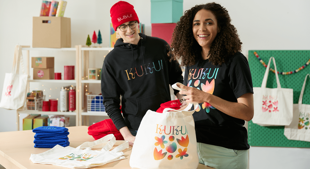 A branded tote bag with flower design in rainbow gradient