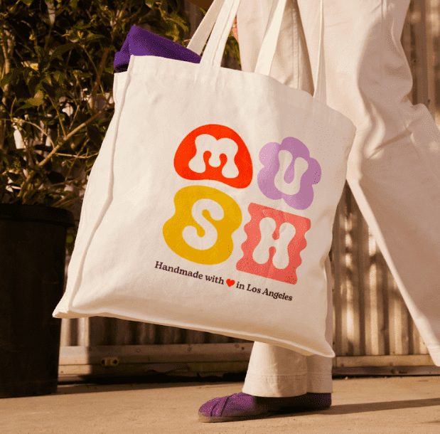 A tote bag with a bright brand logo print