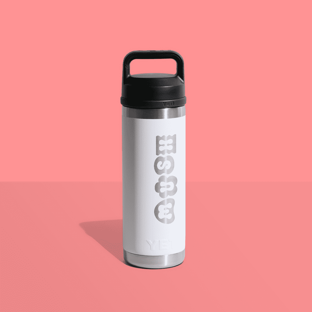 A branded water bottle on a pink background.