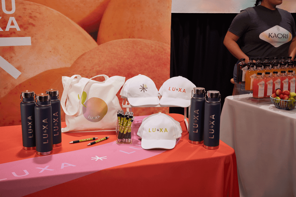 Branded merchandise at a trade show including drinkware and apparel