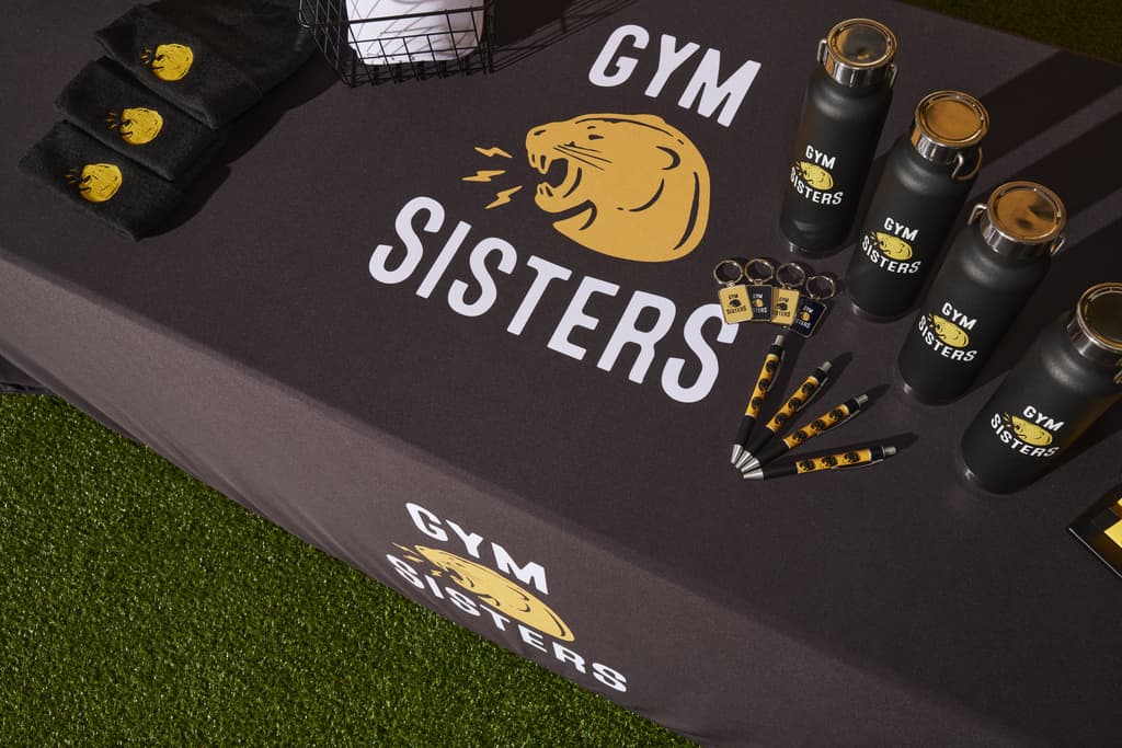 Selection of branded merch for a gym on a table.