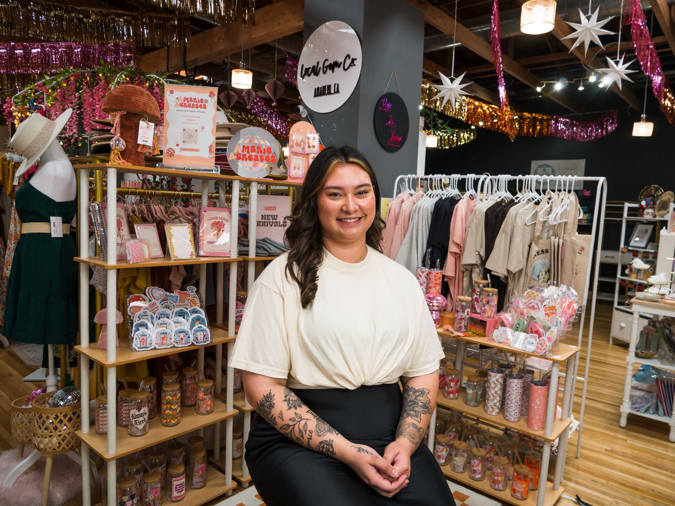 Owner of amariacreates sitting in front of her products.