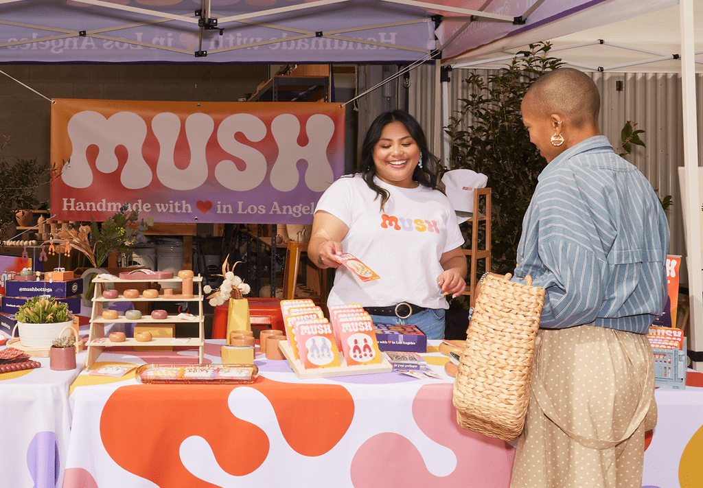 Small business owner networking at a trade show with a customer.
