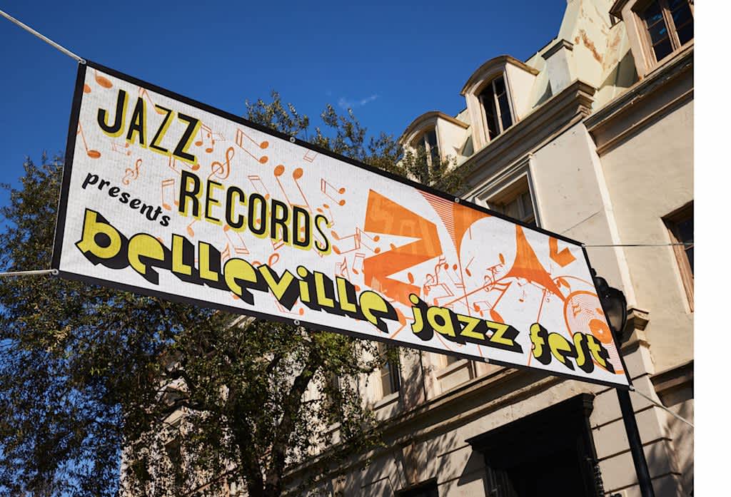 Banner promoting a jazz festival hanging high above a street
