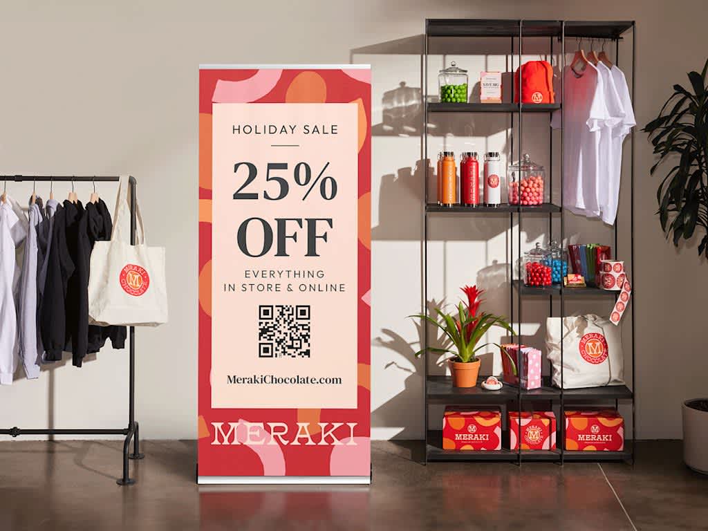 Retractable banner in clothing store advertising holiday sale

