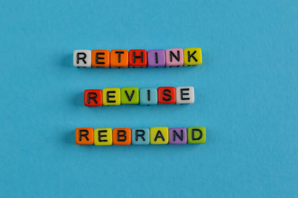 colorful beads spelling out &lsquo;rethink revise rebrand&rsquo;