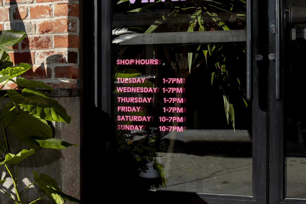 Retail store opening hours window decal using color contrast