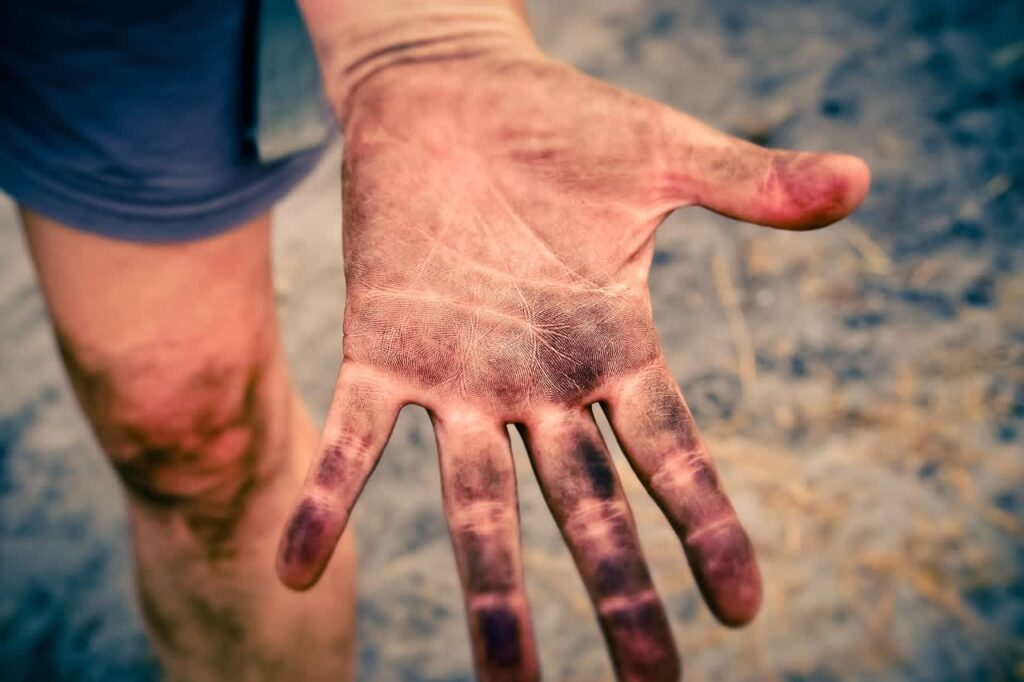 Close-up of a hand with dirt on it