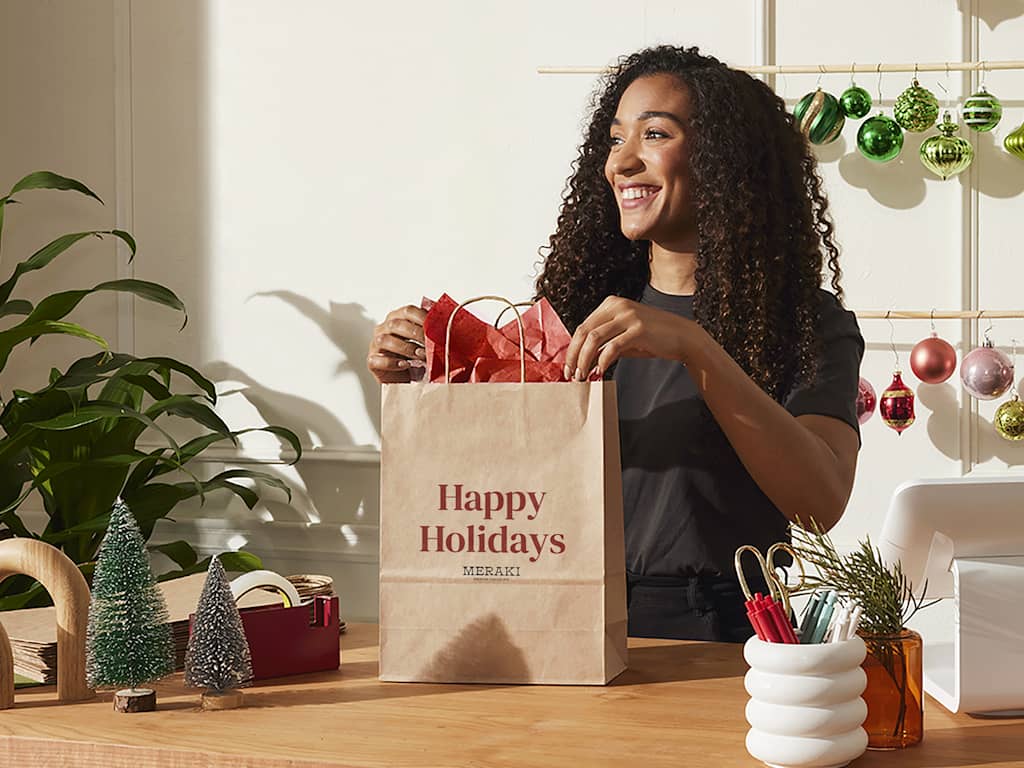 woman filling a brown paper shopping bag on Black Friday
