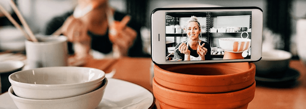 Ceramic artist creating a promotional video selfie for her business.