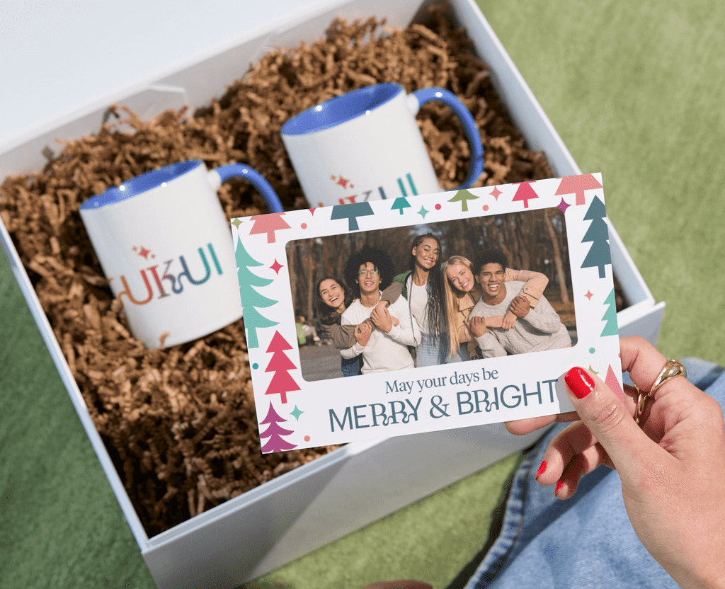 Branded mugs in a holiday gift basket with a customized note