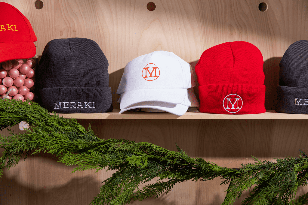 Red, white and gray branded hats for a holiday giveaway