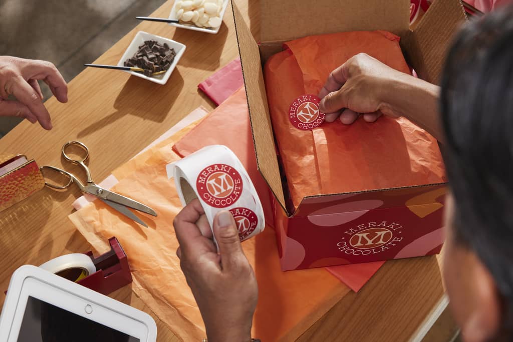Woman adds personalized stickers to gift wrapping