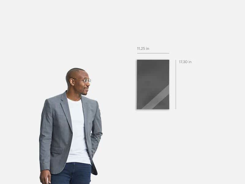 A poster calendar with its measurements, next to a person for comparison