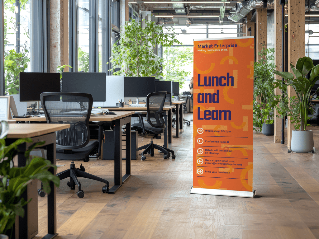 Retractable banner advertising an employee event in an office
