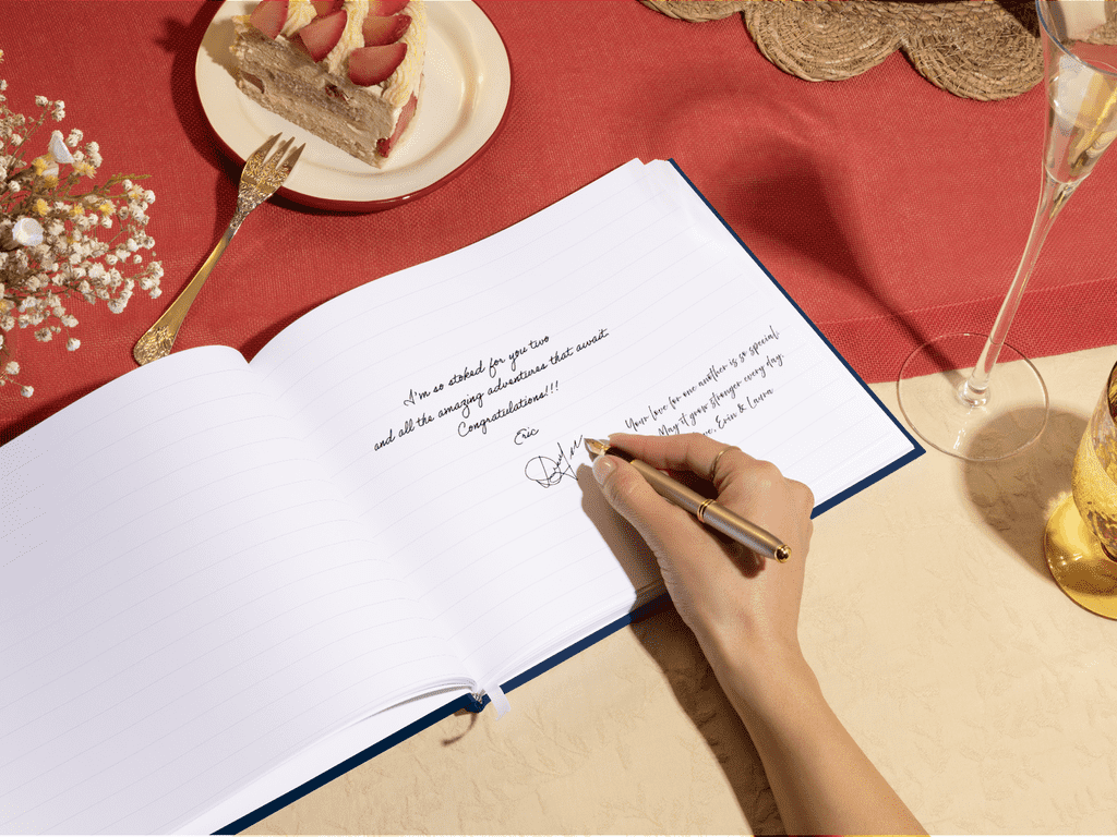 Someone writing in a minimalist guest book at a wedding