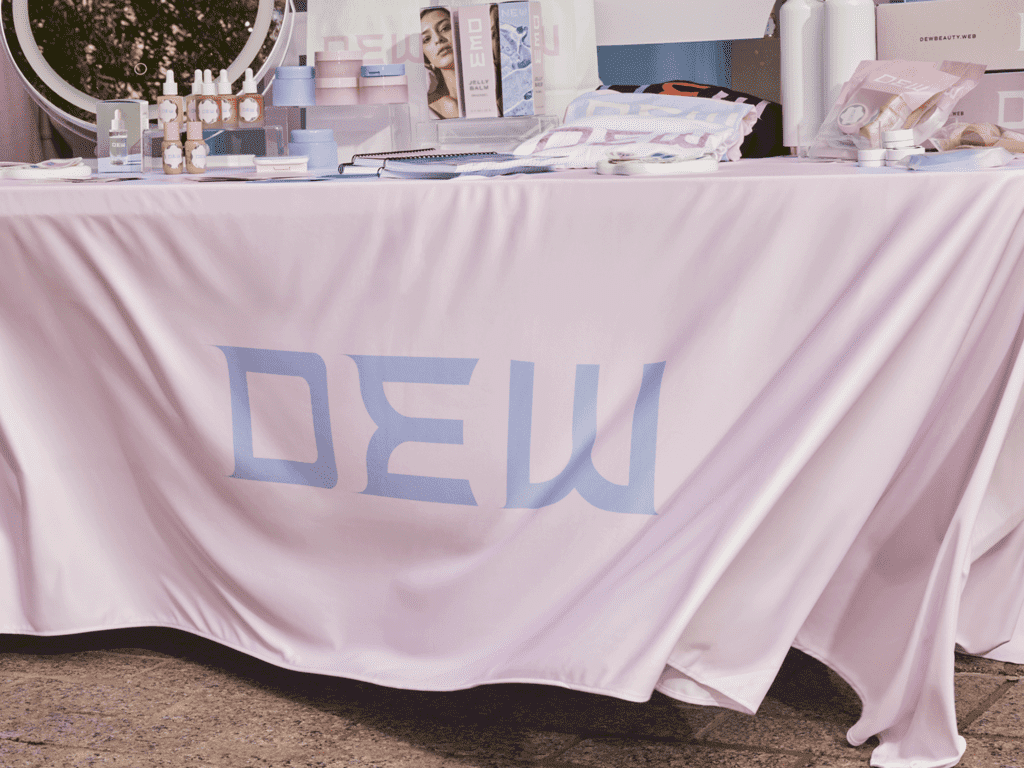 Branded table display with beauty and skincare products, samples and promotional materials at a product launch event