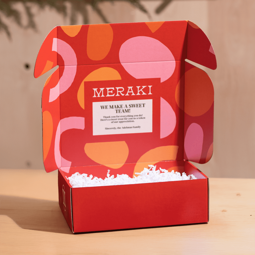 Open red custom branded box with orange and pink graphics and thank you message printed on inner top panel
