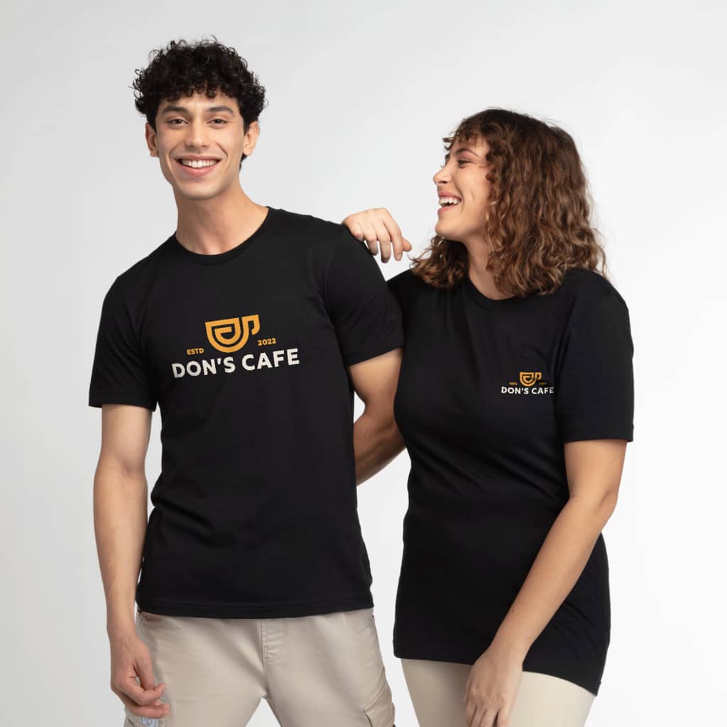 Two people wearing black branded crew neck T-shirts with the brand logo placed on the front, full-chest and left-chest design placements