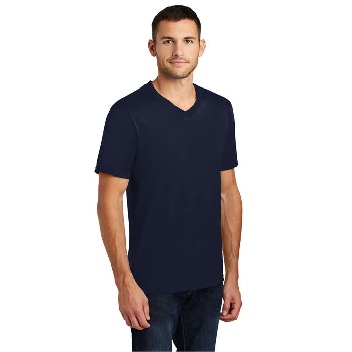A man wearing a navy blue, solid color V-neck T-shirt