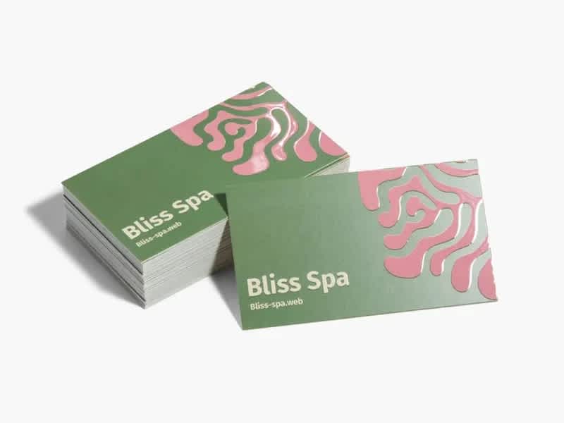 “Inhabitu” business card features white paper stock base with spot gloss design in pink and green accents.