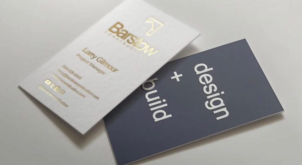 Business card, white on one side with gold text for contact info and navy blue on the other with simple white “Design + Build” text.